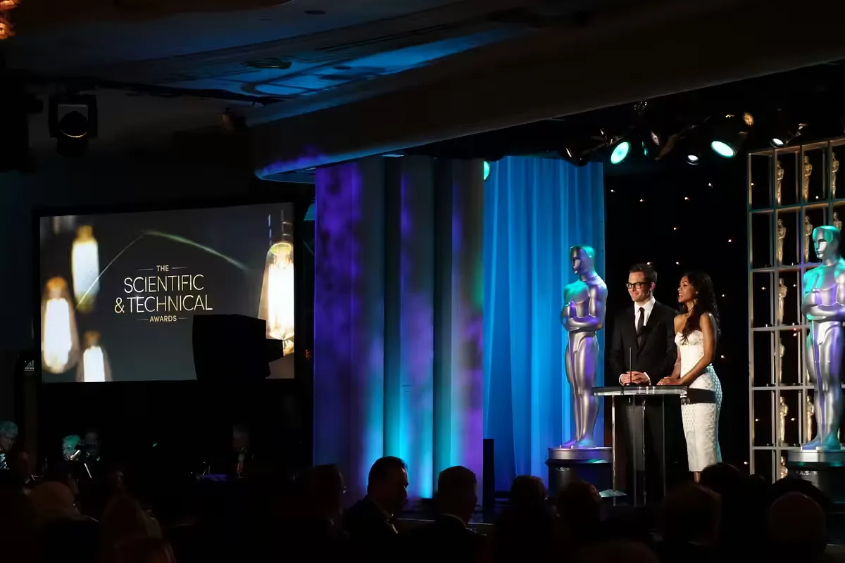 The hosts of the ceremony standing on stage the-hosts